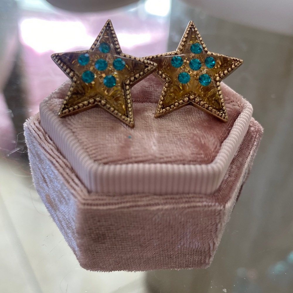Betsey Johnson gold star with teal gem embellishment.
